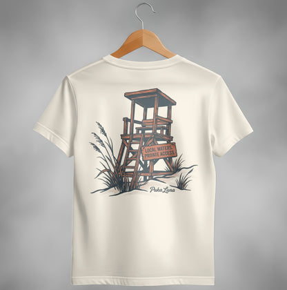 Cream t-shirt with a graphic of a lifeguard stand and text "Local Waters. Private Access."
