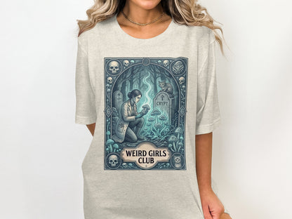 Crypt tombstone with mushrooms and a woman collecting samples, "Weird Girls Club" text.