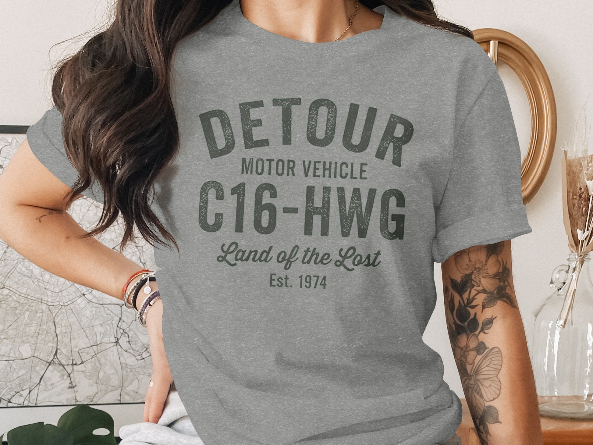 Grey t-shirt with "Detour Motor Vehicle" text and "Est. 1974" date.