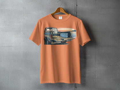 Orange t-shirt with illustration of fishing gear and cooler in truck bed.
