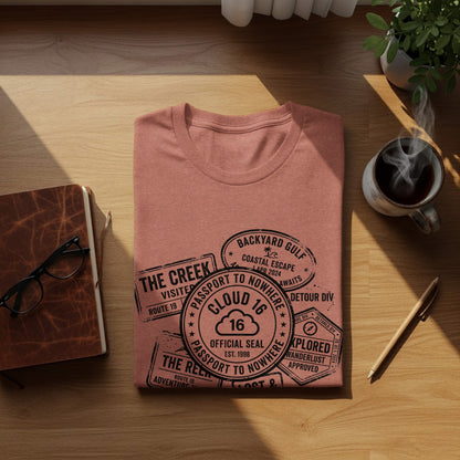 Rugged Wanderlust Passport Stamp Graphic Wilderness Shirt: Coral t-shirt with "Passport to Nowhere" graphic featuring cloud, stamps, and travel-themed text.