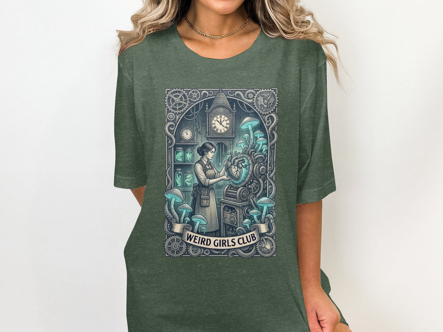 Dark green t-shirt with "Weird Girls Club" and a steampunk-inspired anatomical heart illustration.