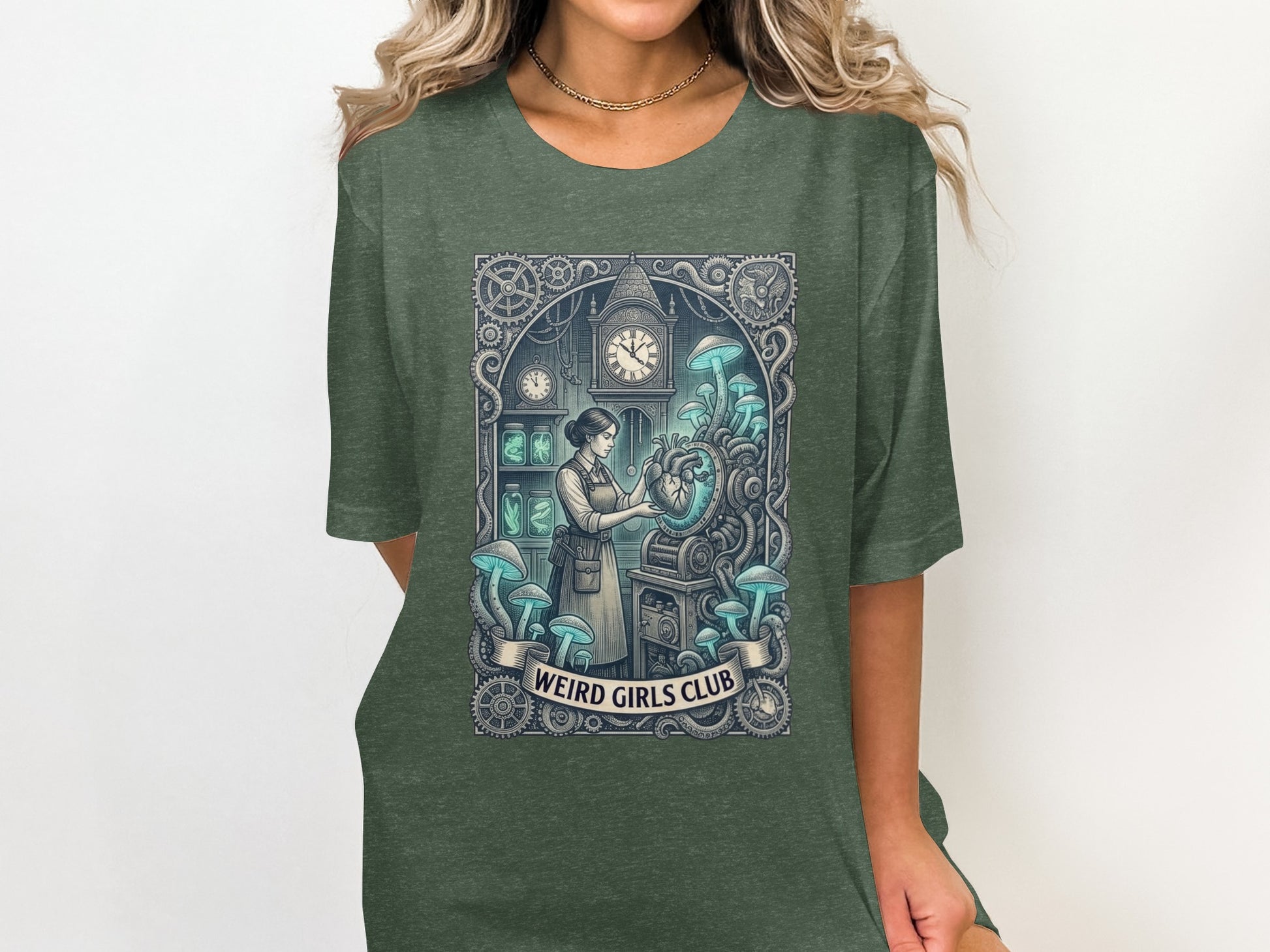 Dark green t-shirt with "Weird Girls Club" and a steampunk-inspired anatomical heart illustration.