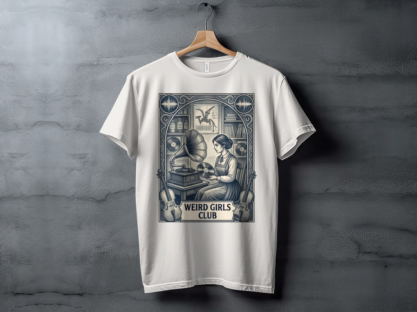 White t-shirt with graphic of woman playing record player, "Weird Girls Club" text.