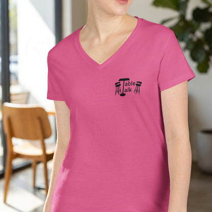 Pink V-neck t-shirt with "Table Talk" and a table with two chairs graphic.