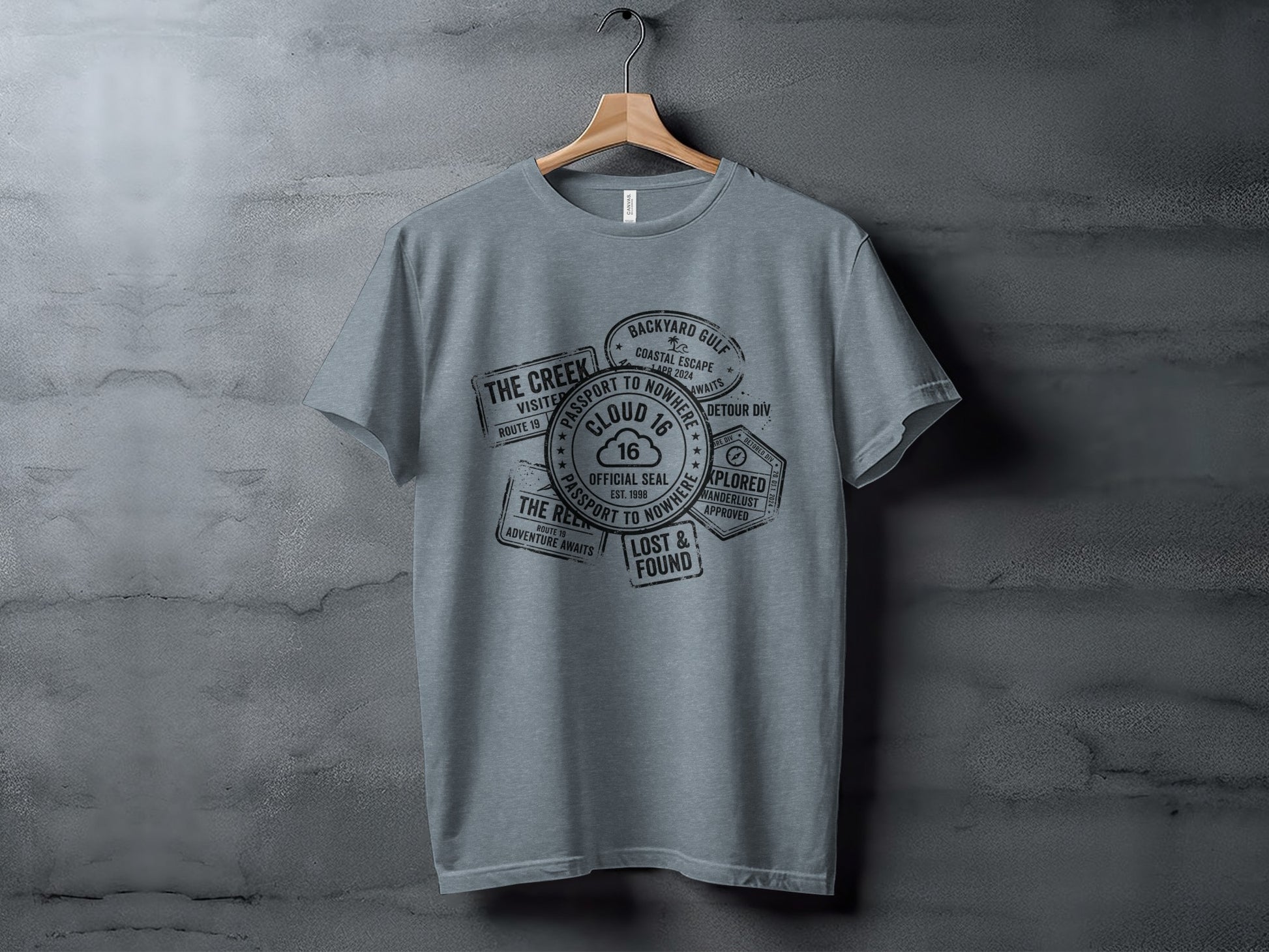 Rugged Wanderlust Passport Stamp Graphic Wilderness Shirt: Gray t-shirt with passport stamp graphic featuring "Cloud 16" and travel phrases.