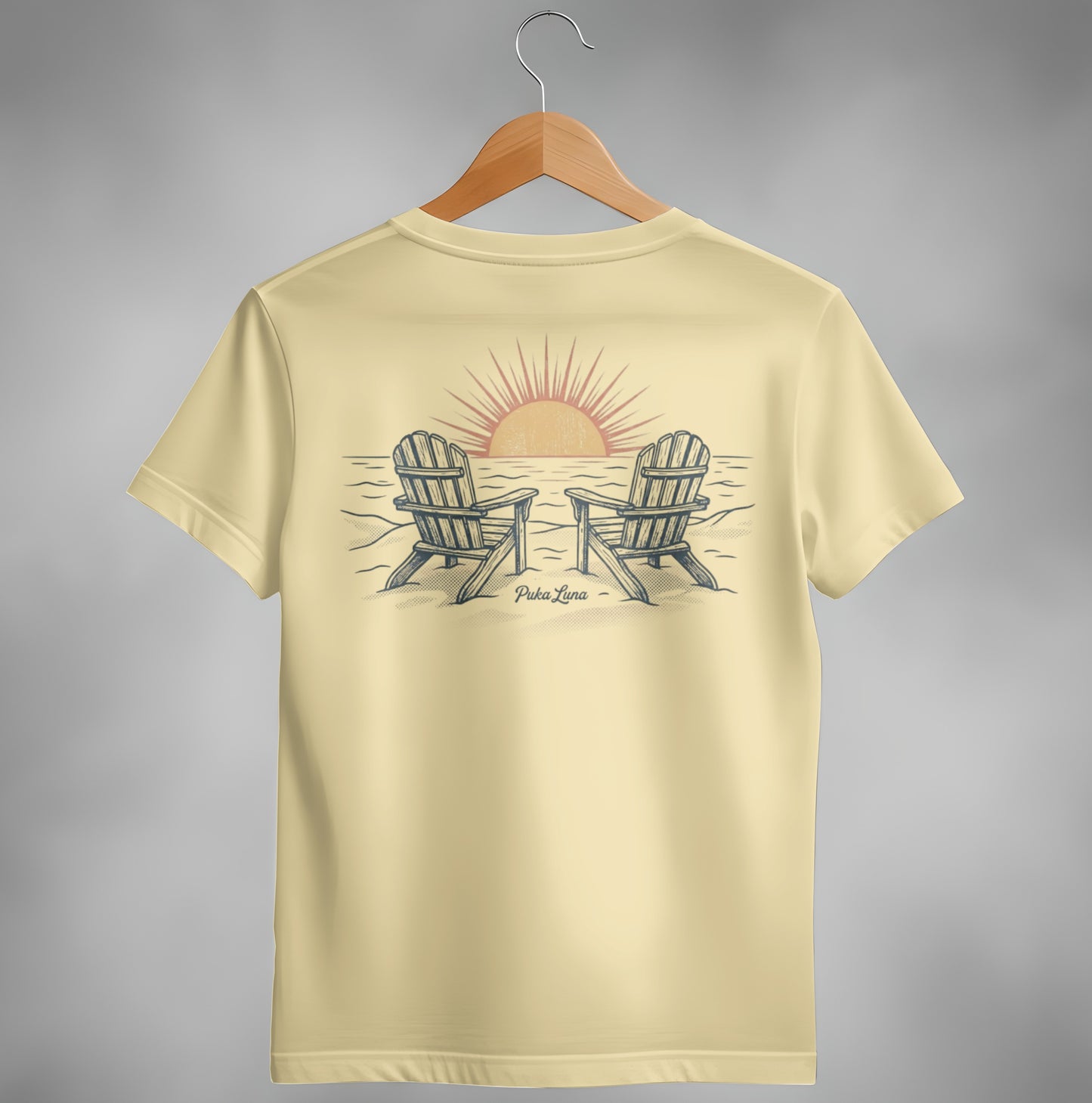Yellow t-shirt with two Adirondack chairs facing a sunset over the ocean.