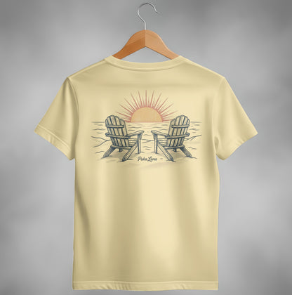 Yellow t-shirt with two Adirondack chairs facing a sunset over the ocean.