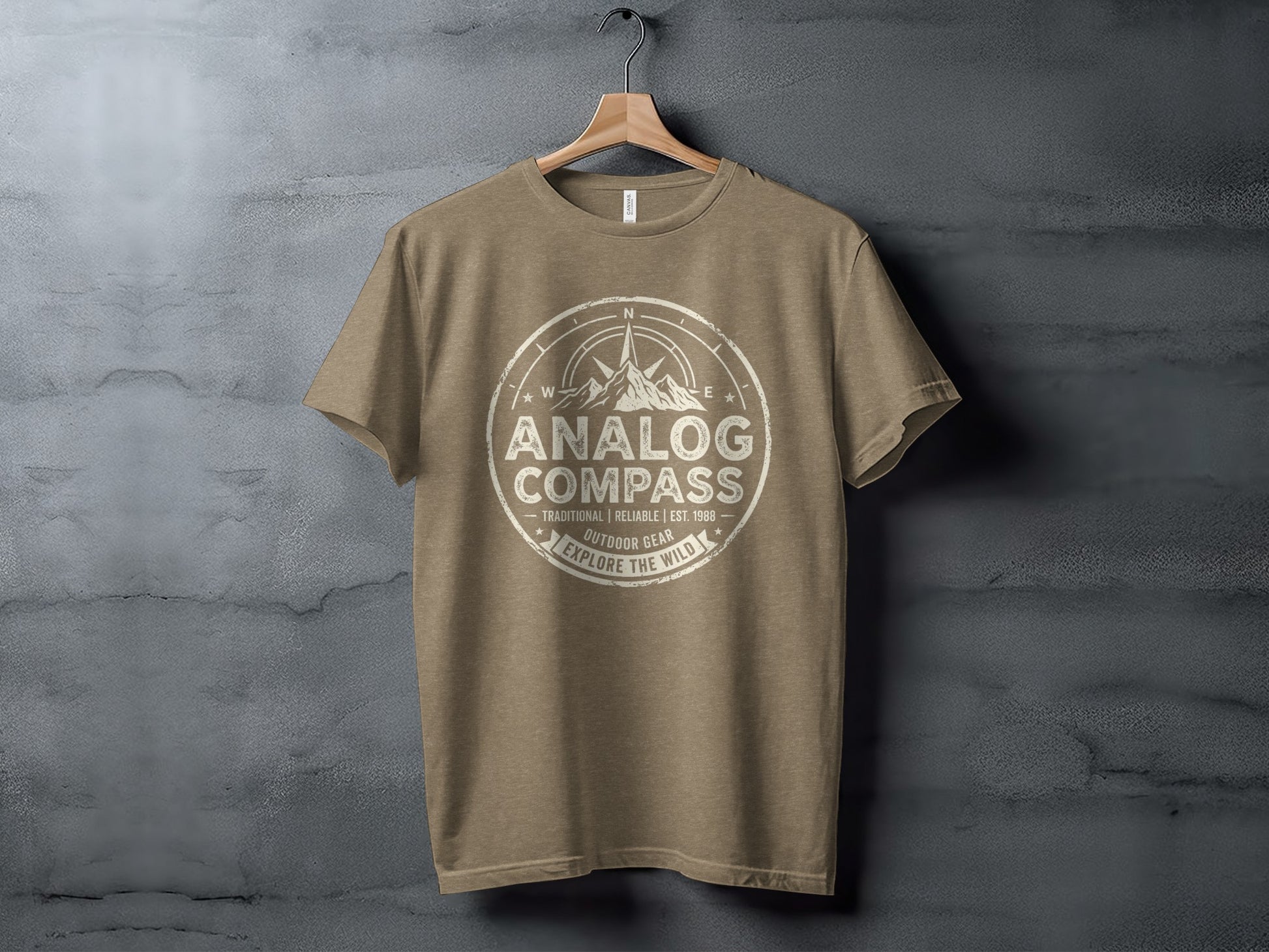 Analog Compass Heritage: The Explorer's Adventure Tee: Tan t-shirt with "Analog Compass Outdoor Gear" text and compass graphic.