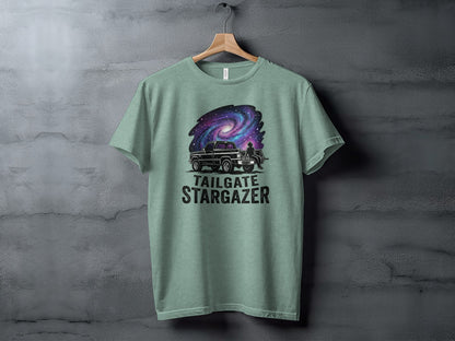Heritage Cosmic Tailgate Stargazer Nomad Tee: T-shirt with a black truck under a colorful galaxy and "Tailgate Stargazer" text.