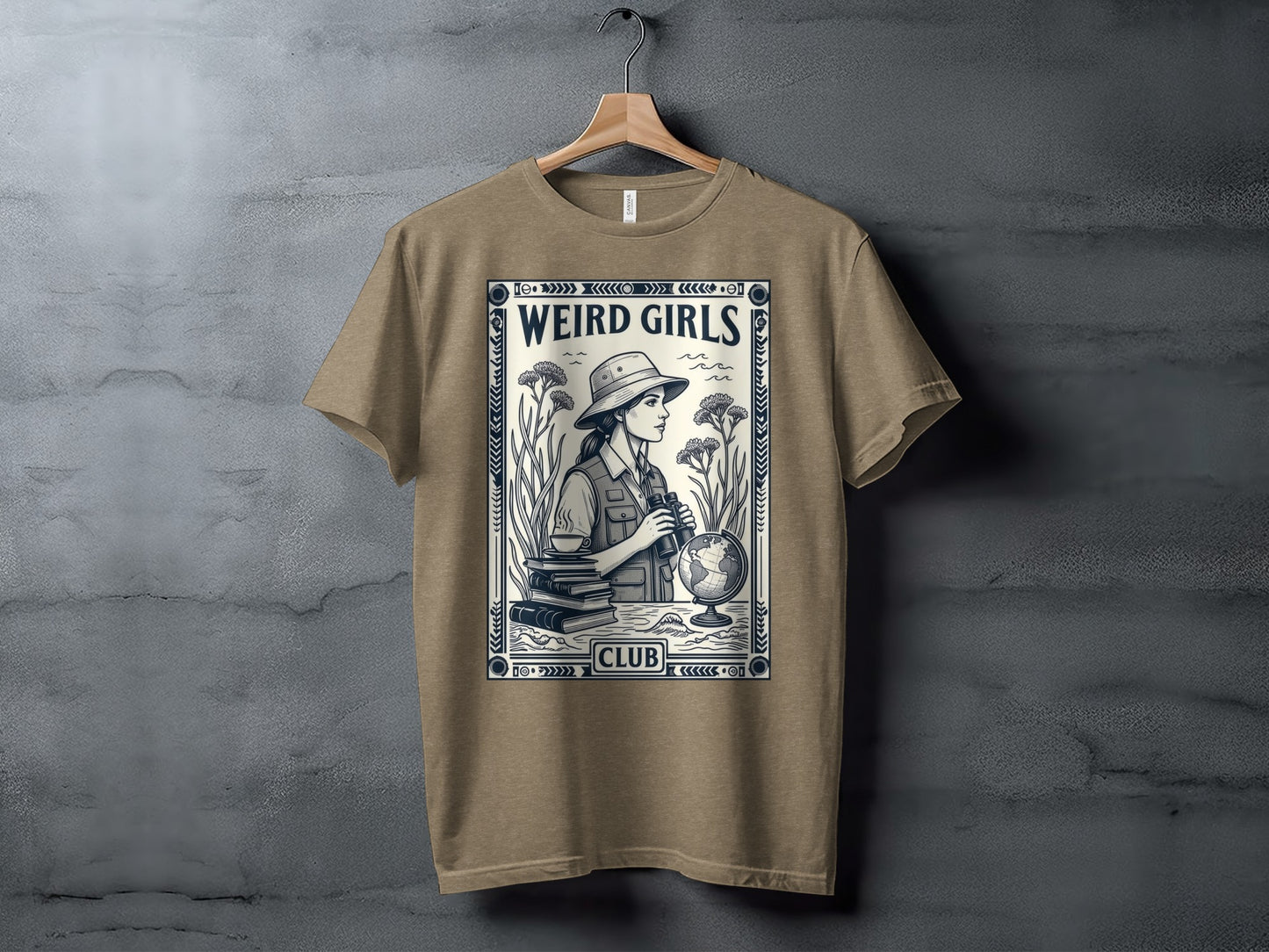 T-shirt graphic of a woman with binoculars, books, and a globe, with "Weird Girls Club" text.