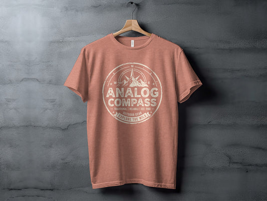 Analog Compass Heritage: The Explorer's Adventure Tee: Salmon t-shirt with "Analog Compass Outdoor Gear" and compass graphic.