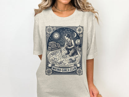 Graphic tee with celestial map and "Weird Girls Club" text.