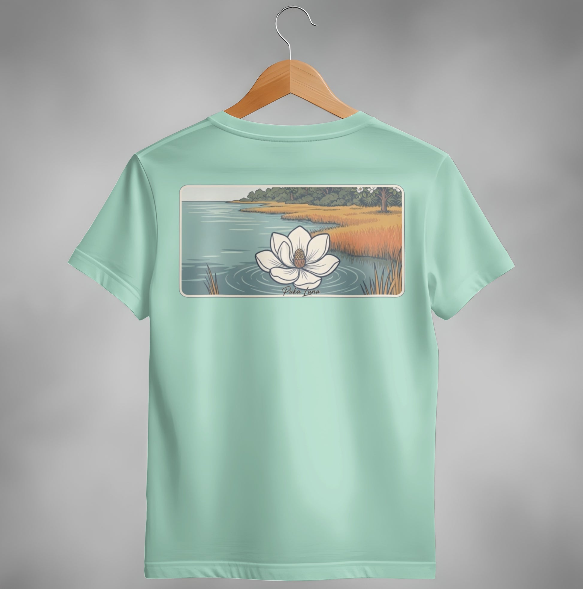 Mint green t-shirt with a white water lily design on the back.