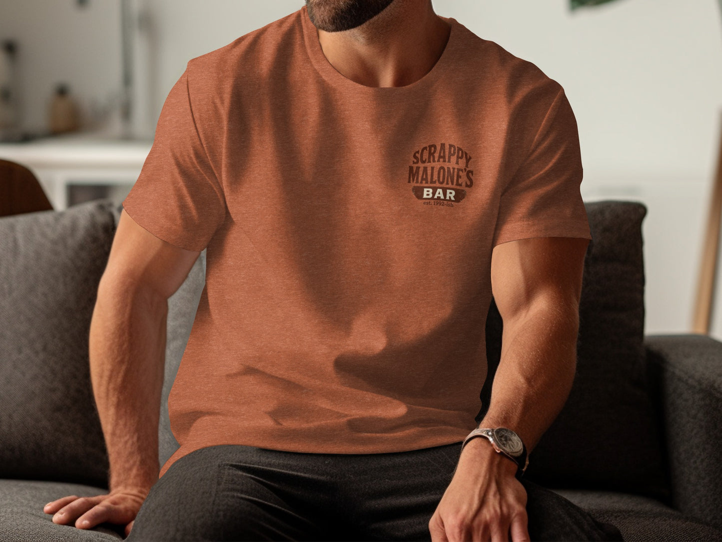 Orange t-shirt with "Scrappy Malone's Bar" logo on chest.