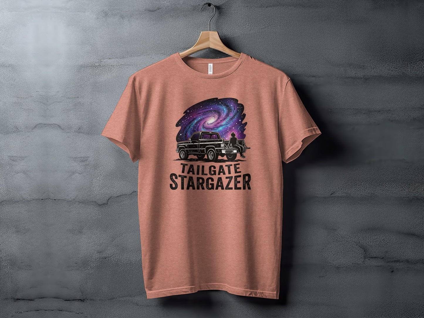 Heritage Cosmic Tailgate Stargazer Nomad Tee: T-shirt with a graphic of a truck and a galaxy, reading "Tailgate Stargazer".