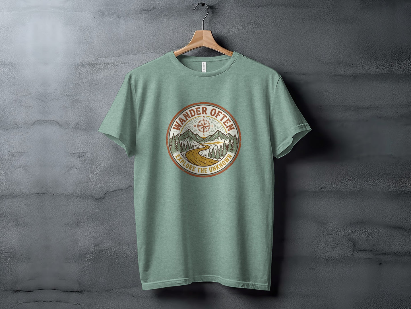 The Original Wander Often Vintage Explorer Adventure Top: Green t-shirt with circular mountain landscape design and text "Wander Often Explore the Unknown".
