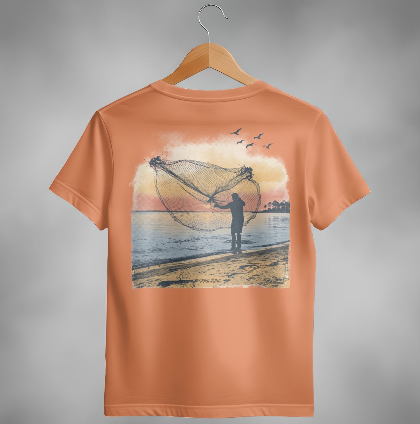 Back of orange t-shirt with a fisherman casting a net at sunset.