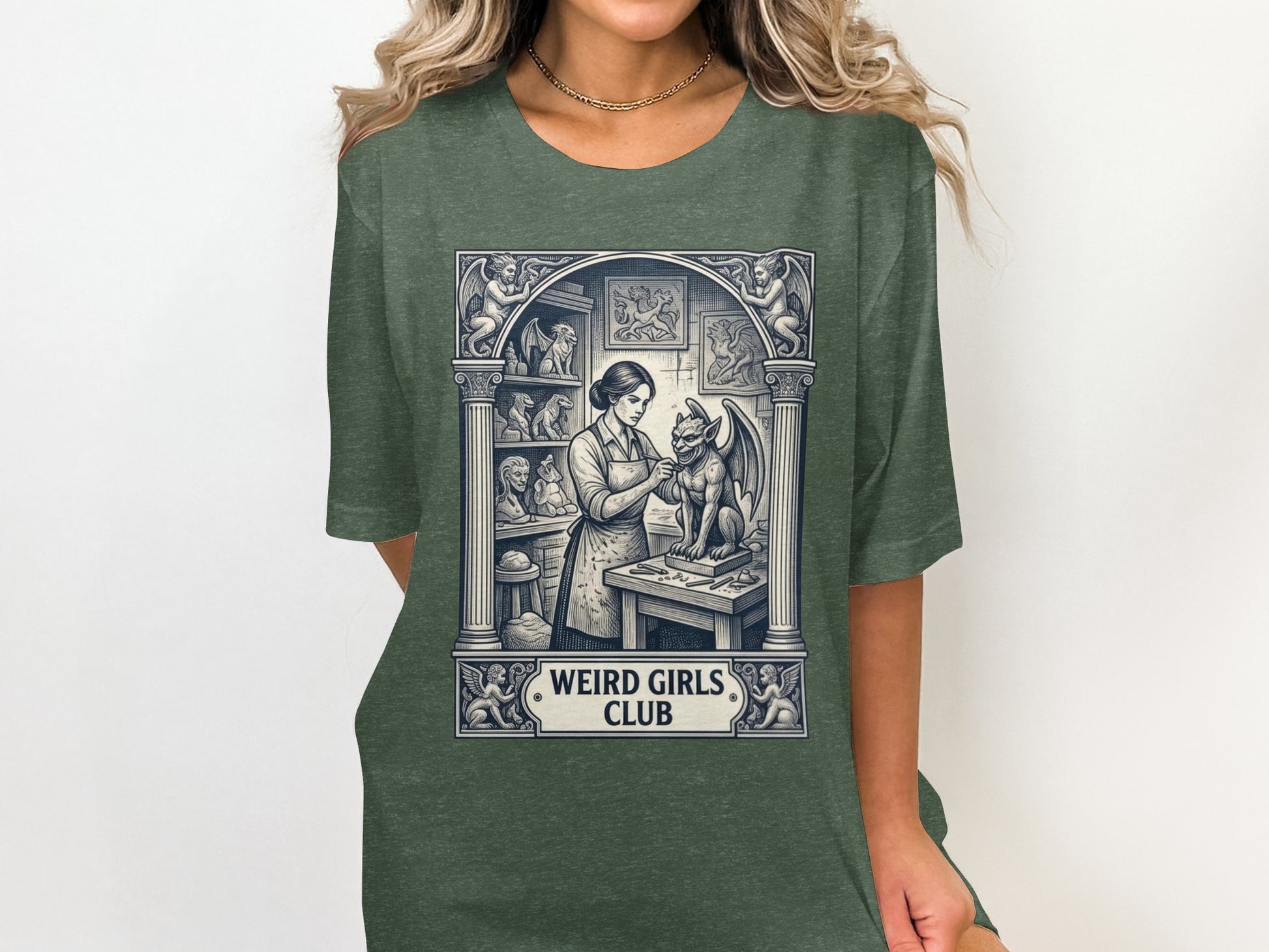 T-shirt graphic with woman sculpting a gargoyle, "WEIRD GIRLS CLUB" text.