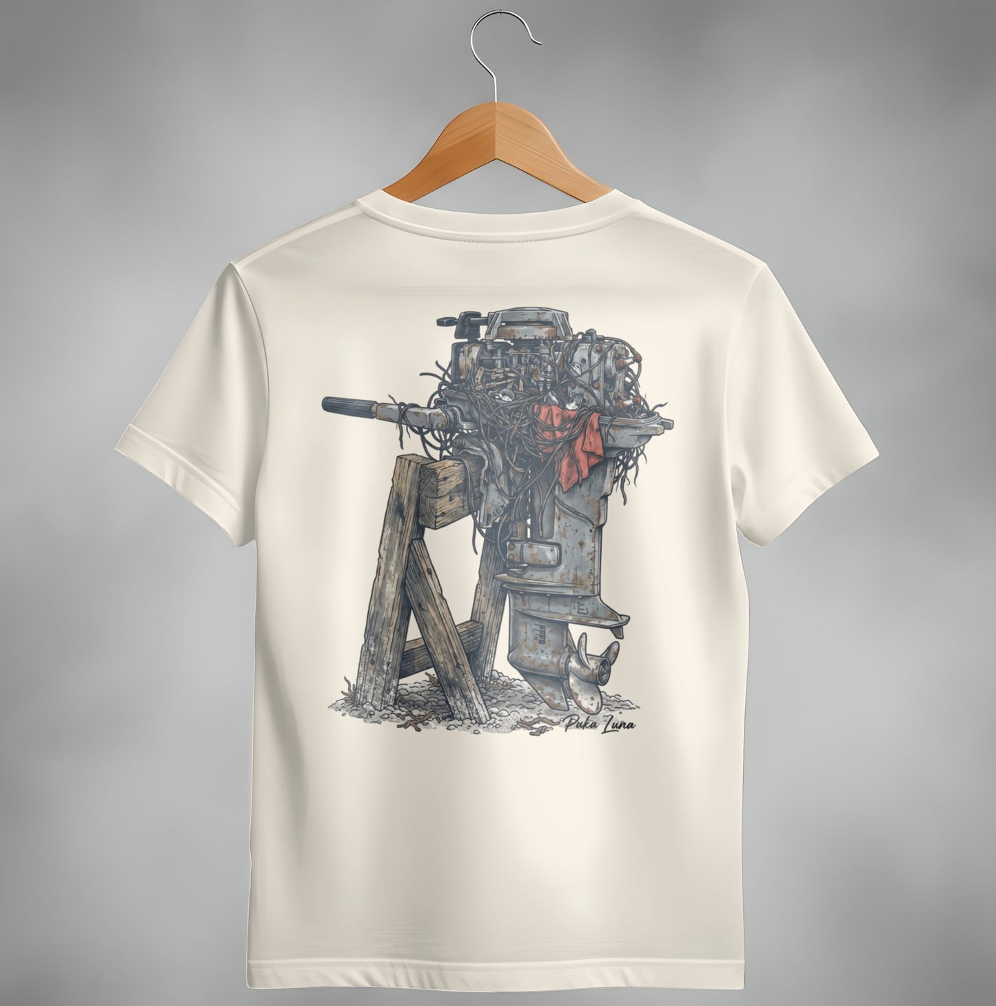 Cream t-shirt with illustration of a weathered outboard motor on a wooden stand.