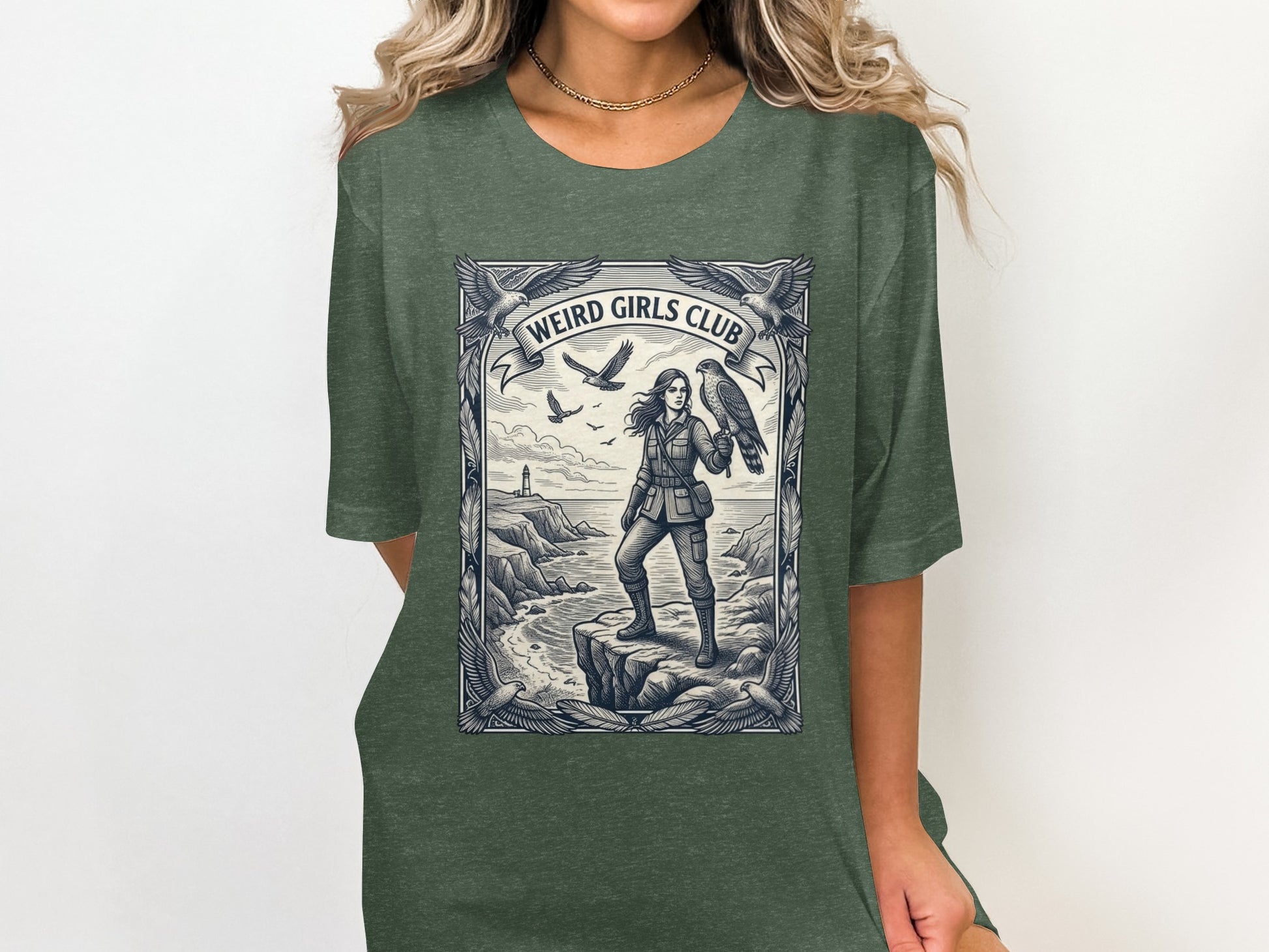 Woman wearing t-shirt with graphic of woman and eagle on cliff.