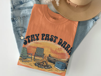 Orange t-shirt with "Stay Past Dark" text over a camping scene.