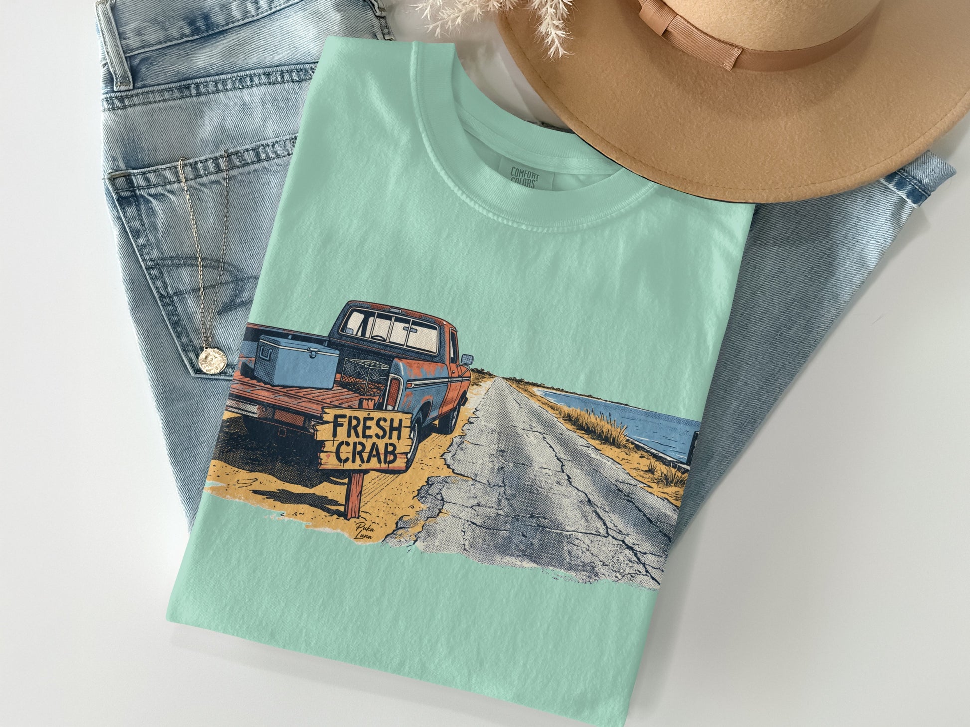 Light blue t-shirt with graphic of vintage red truck and "Fresh Crab" sign.