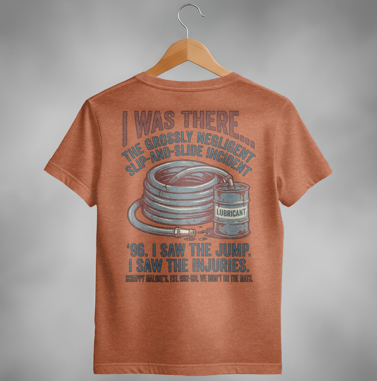 T-shirt with text about a slip-and-slide incident, lubricant can, and hose.