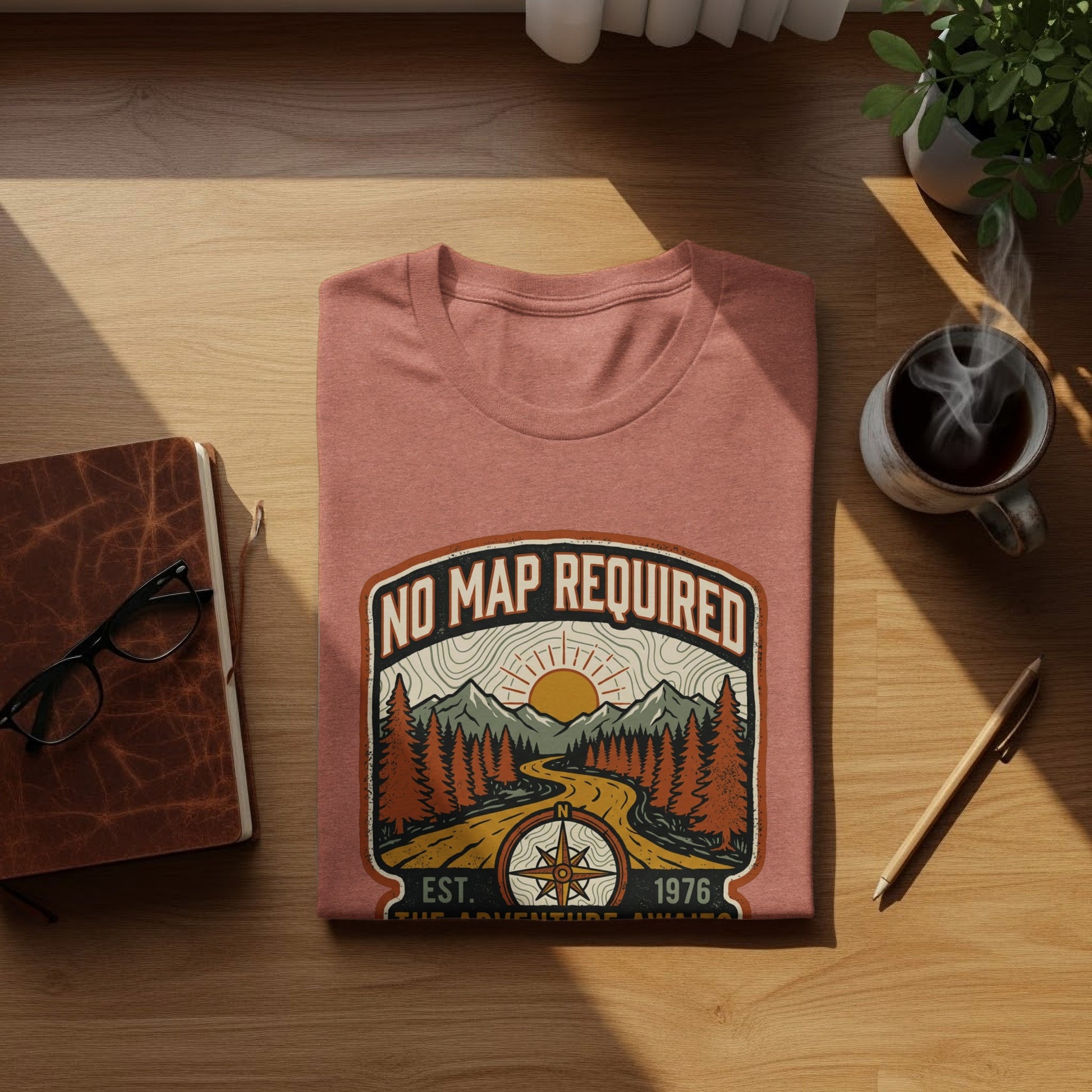 Heritage No Map Required: The Adventure Awaits Nomad Tee: T-shirt with "No Map Required" and compass graphic, featuring mountains and trees.