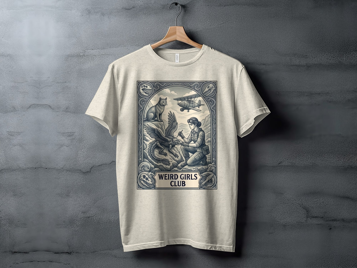Cream t-shirt with a vintage graphic featuring a woman, eagle, cat, and biplane.