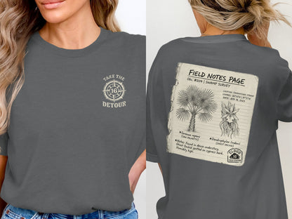 T-shirt with "Take the Detour" logo and "Field Notes Page" graphic detailing a swamp survey.