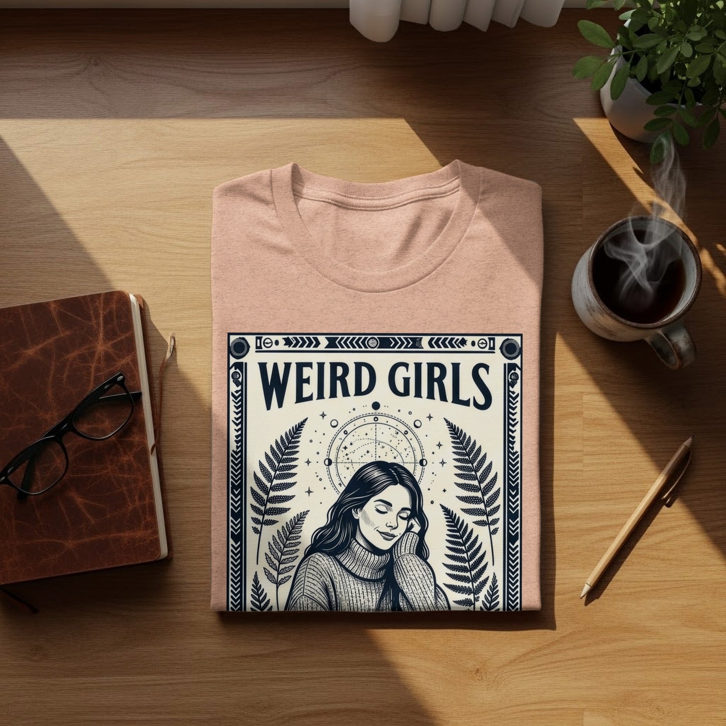 Pink t-shirt with "Weird Girls" text and celestial design.