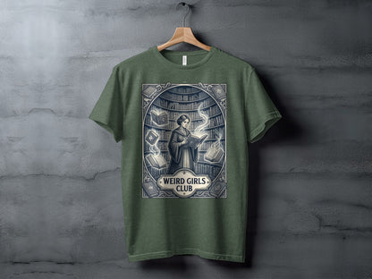 Green t-shirt with "Weird Girls Club" text and a woman reading surrounded by books.