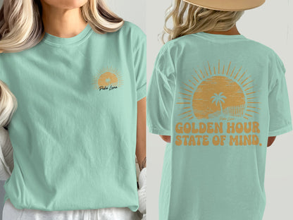 Mint t-shirt with sunset and palm tree graphic, "Puka Luna" and "Golden Hour State of Mind."