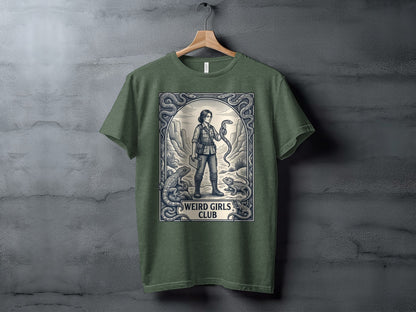 T-shirt graphic featuring a woman holding a snake surrounded by lizards and ornate border.
