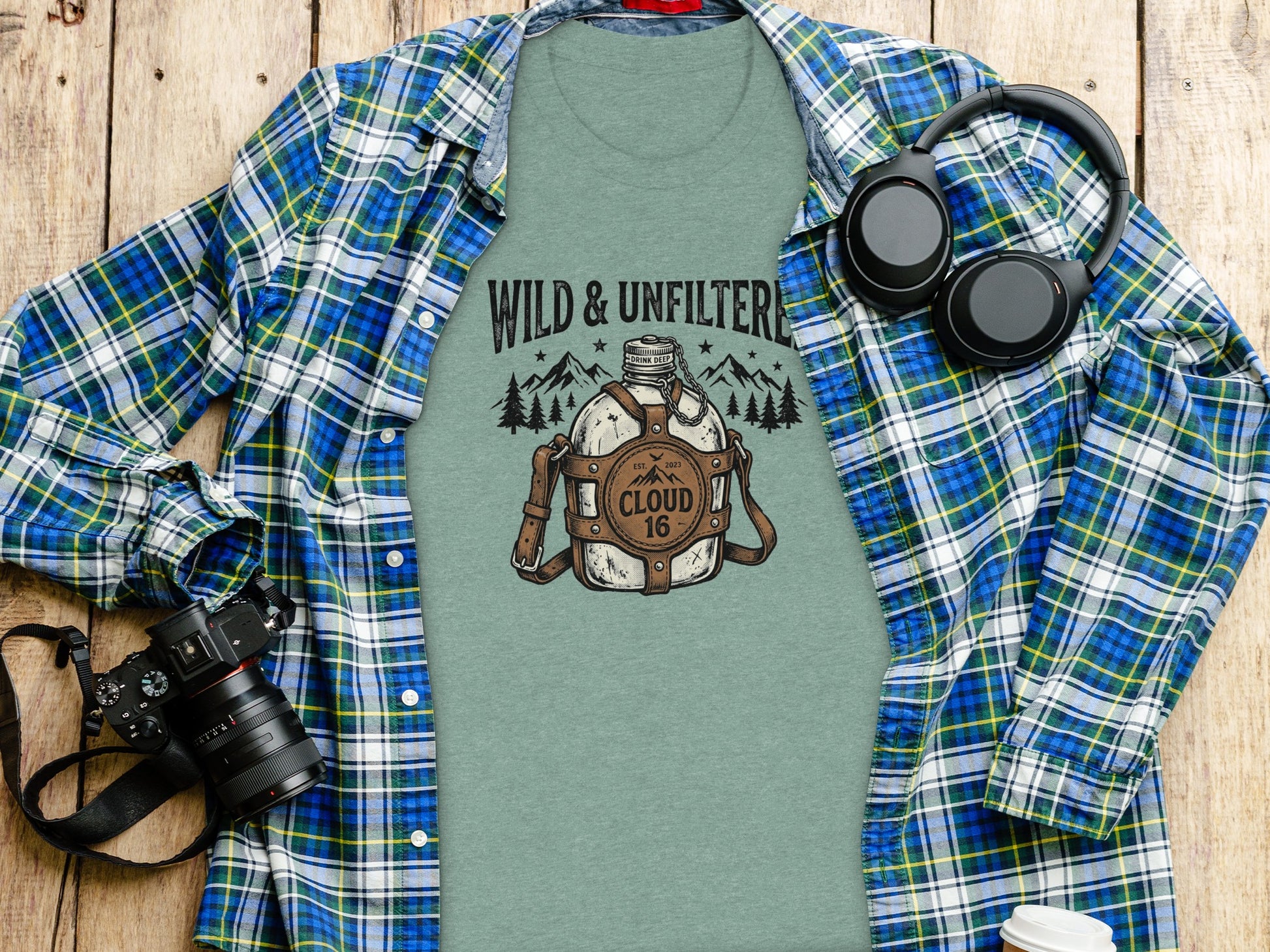 Rugged Wild & Unfiltered Spirit Wilderness Shirt: Green t-shirt with "Wild & Unfiltered Cloud 16" graphic, headphones, and camera.
