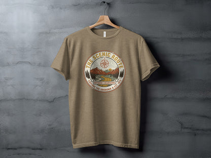 Heritage Scenic Route Vintage Explorer Tee Nomad Tee: Brown t-shirt with "The Scenic Route" circular graphic and mountain illustration.