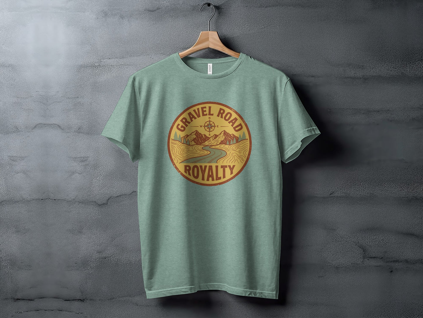 Gravel Road Royalty Adventure Tee | Vintage Outdoor Apparel: Green t-shirt with "Gravel Road Royalty" circular logo featuring mountains and a road.
