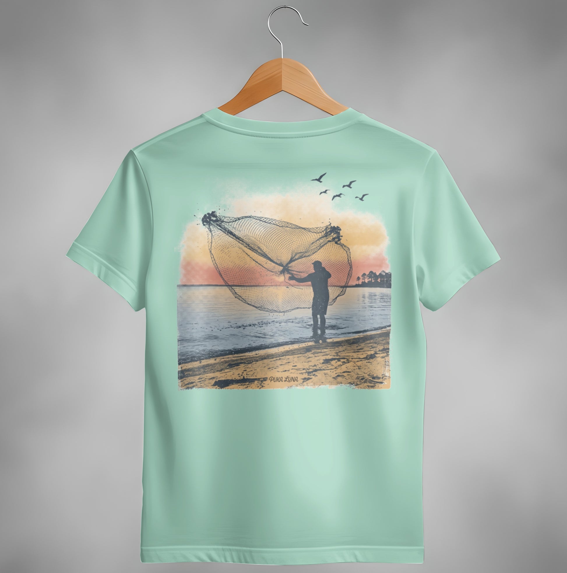 Fisherman casting net at sunset over water with birds flying overhead.