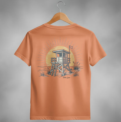 Orange t-shirt featuring a retro lifeguard tower illustration at sunset.