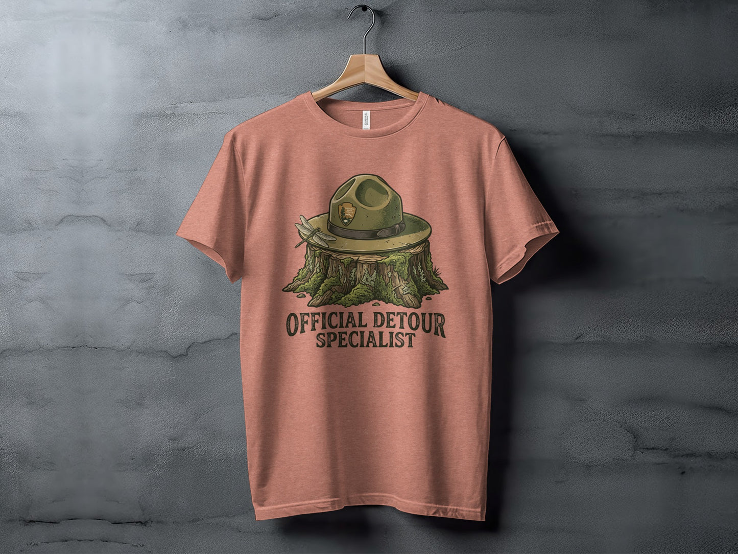 Official Detour Specialist Heritage | Vintage Outdoor Apparel: T-shirt with green ranger hat on stump, "Official Detour Specialist" text.