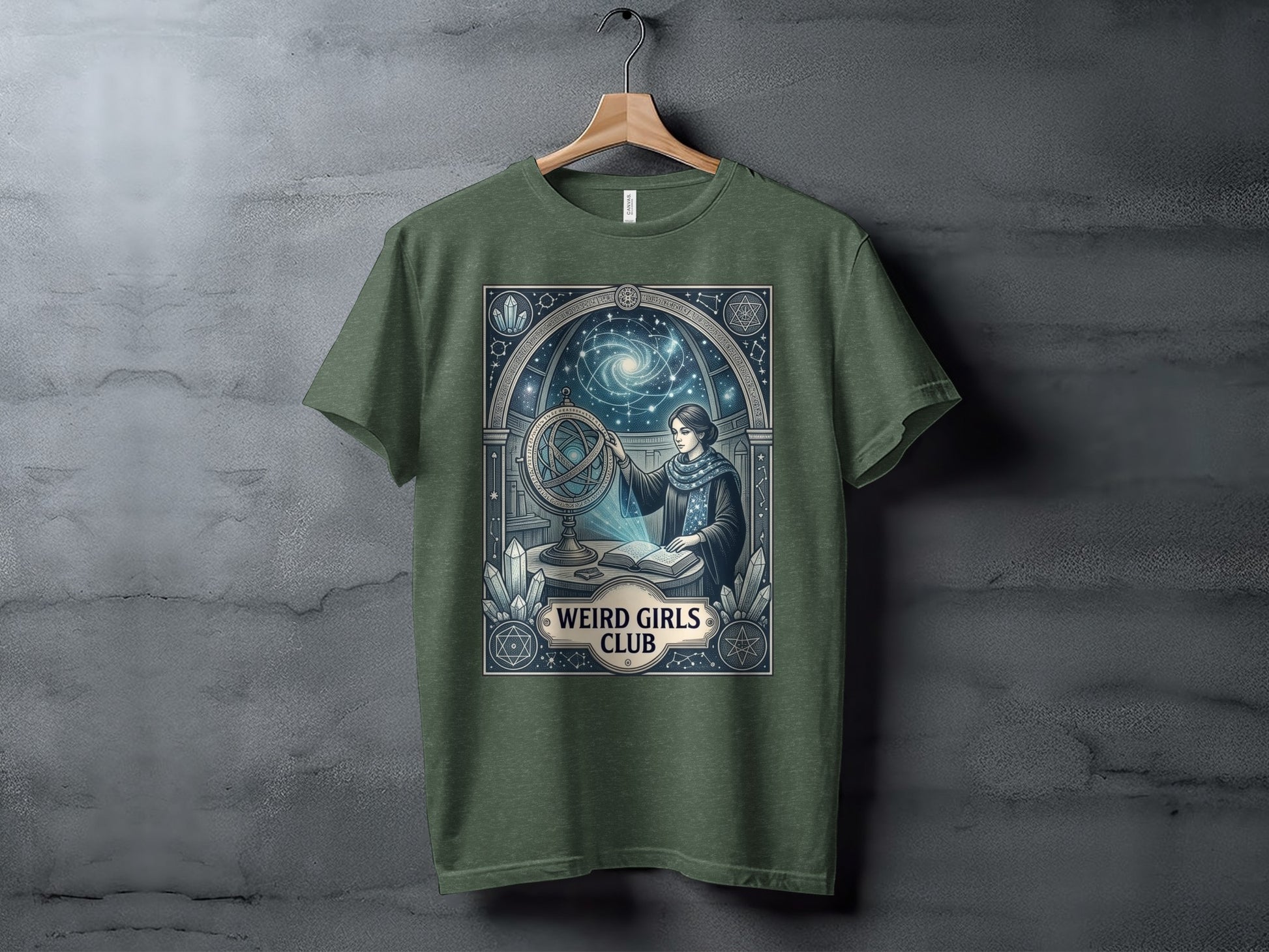 Green t-shirt with celestial-themed graphic featuring a woman with an orrery.