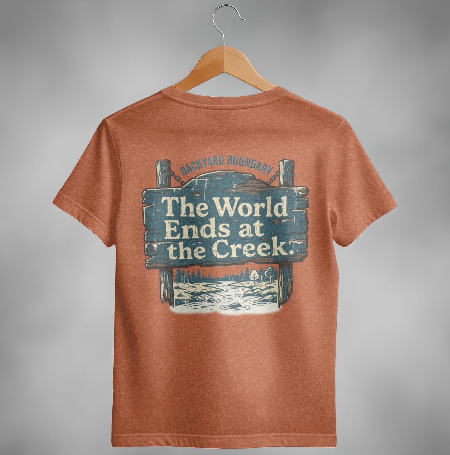 Orange t-shirt with "The World Ends at the Creek" sign graphic.