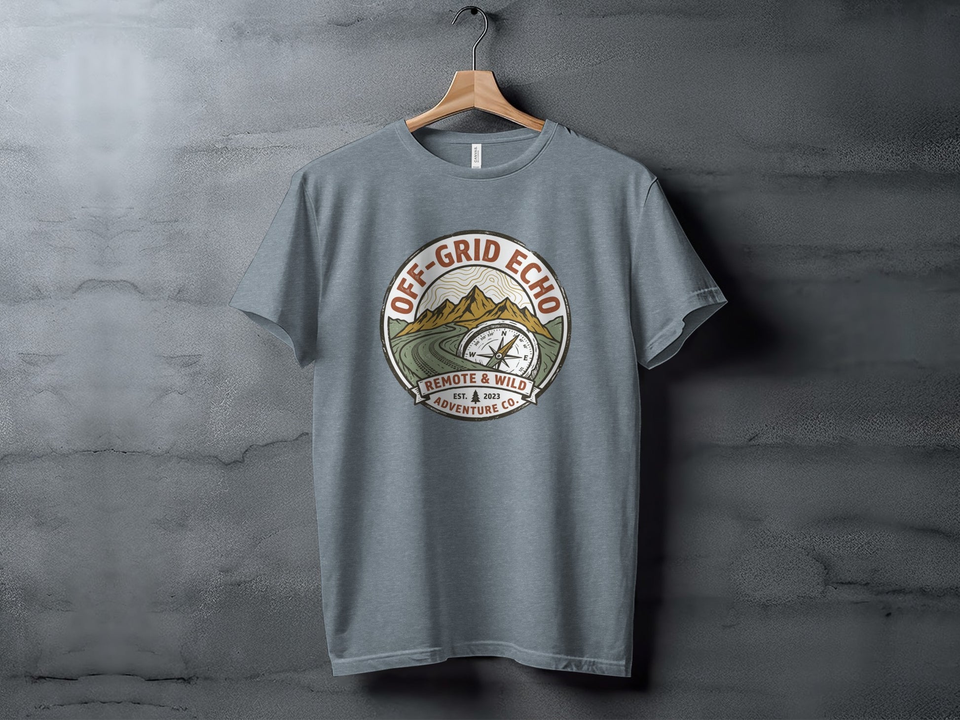 Off-Grid Echo Explorer: The Explorer's Adventure Tee: Gray t-shirt with Off-Grid Echo logo, compass, mountains, and "Remote & Wild Adventure Co." text.