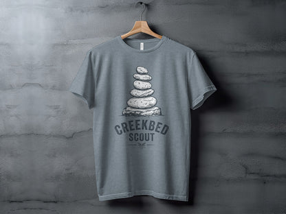 Creekbed Scout Cairn Graphic: The Explorer's Adventure Tee: Gray t-shirt with stacked stones and "Creekbed Scout" text.