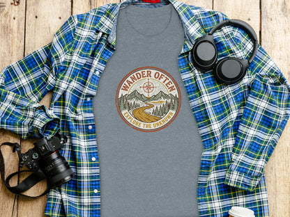 The Original Wander Often Vintage Explorer Adventure Top: Gray t-shirt with "Wander Often Explore the Unknown" graphic, alongside a camera and headphones.