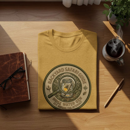 Backyard Safari Guide Explorer: Backcountry Outpost Shirt: Yellow t-shirt with "Backyard Safari Guide Hose Water Gen" embroidered circular logo.