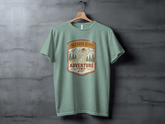 Rugged Creekbed Scout Adventure Emblem Wilderness Shirt: Creekbed Scout Adventure t-shirt with mountain and road graphic.