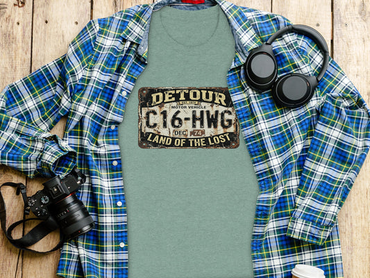 Detour 'Land of the Lost' Vintage | Vintage Outdoor Apparel: Green t-shirt with a "Detour Land of the Lost" license plate graphic.