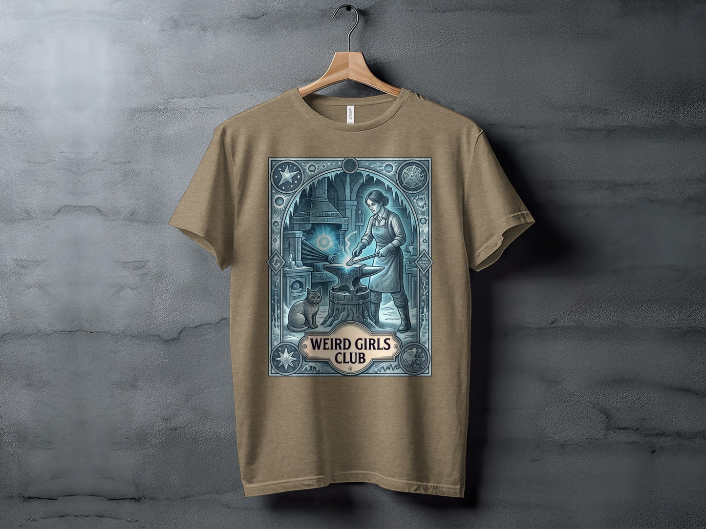 Brown t-shirt with an anvil, blacksmith, cat, and "Weird Girls Club" text.